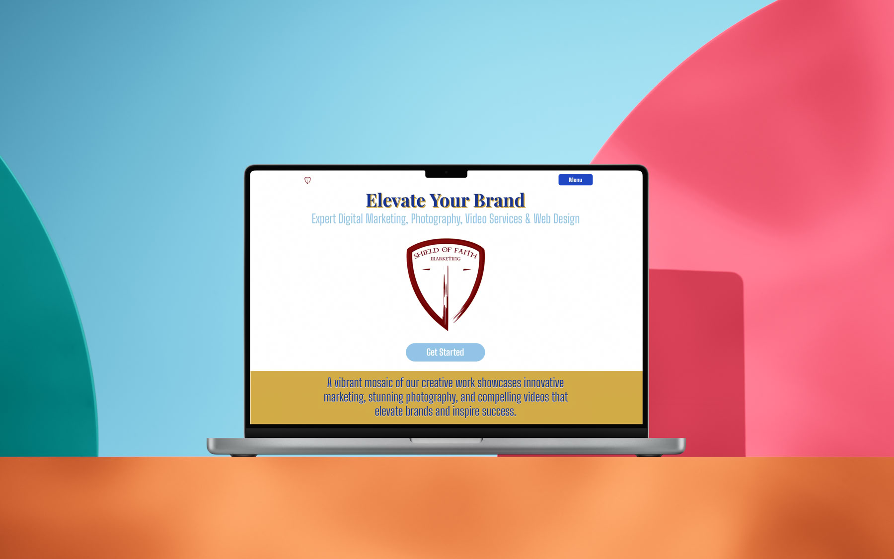A laptop displaying a website with a shield logo and the text "Elevate Your Brand" on the screen, set against a colorful background with blue, red, and green shapes.